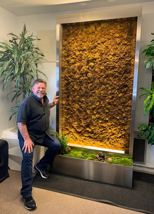 Jim Mumford with a new living moss wall system.