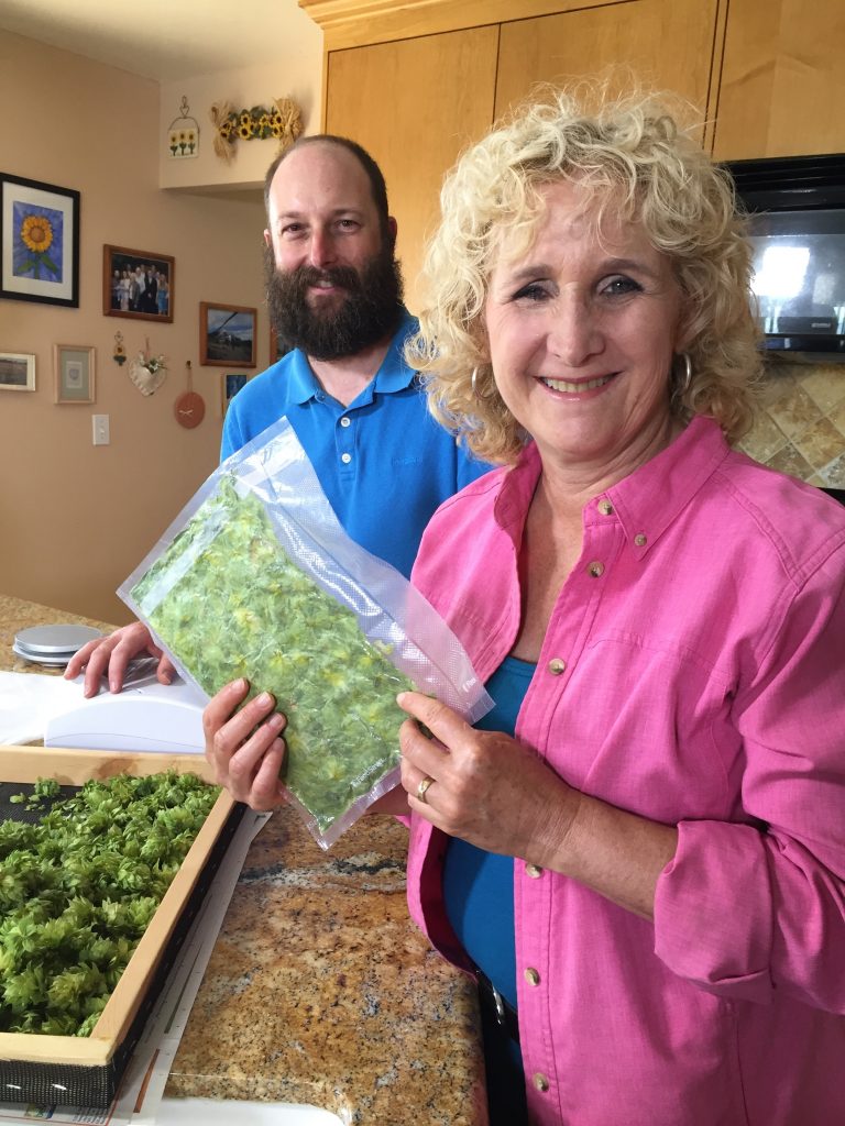 Nan Sterman with a bag of hops grown by home hop grower and home brewer Sean Gardinier. Photo Courtesy Nan Sterman