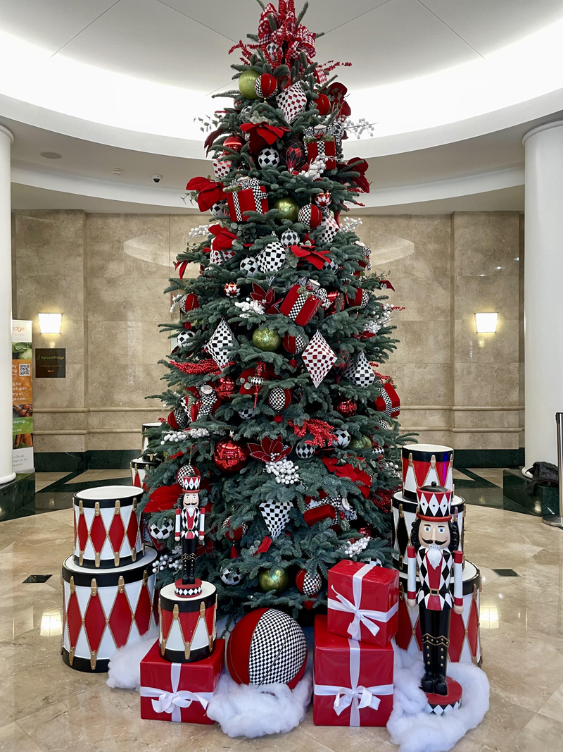 Clients are going for fun, lighthearted desigs. This live 12 foot tall tree is decorated in red and black, with 12 large drums, soldiers, and matching velvet balls. Photo: Whinney Designs Christmas in March
