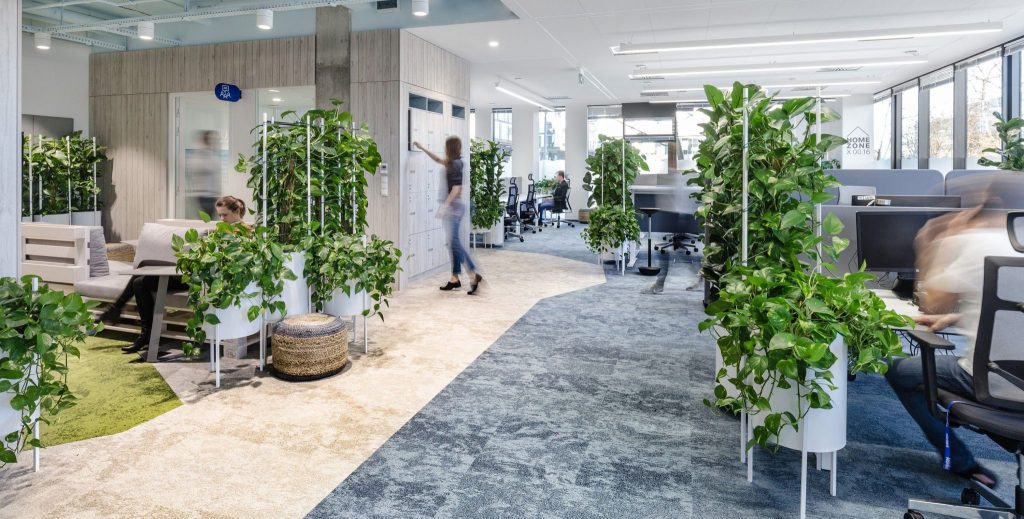 People being productive in an office surrounded by plants