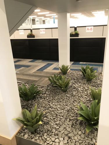 Under the stairway are replica Agaves with combination replica succulent planters on file cabinets.
