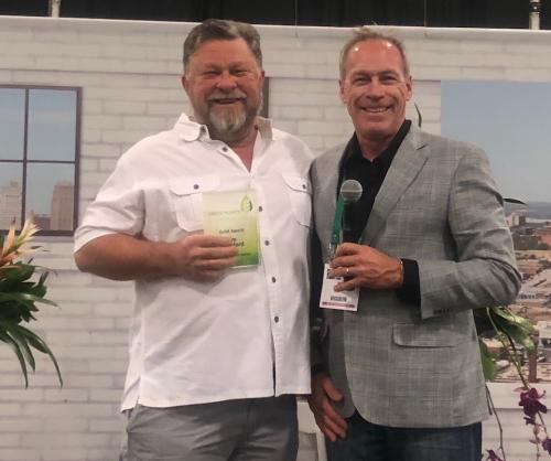 Jim Mumford wins second place among the conference's most popular presentations. Jim spoke about living walls and biophilic design. Green Plants for Green Buildings president Mark Senneff presents Jim his award.