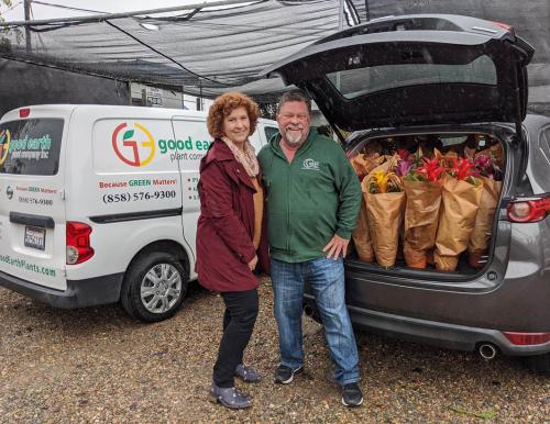 UCSD Hearts & Hands Volunteer Doula Program manager Ann Fulcher picks up donated plants from Jim Mumford at Good Earth Plant Company's  headquarters. 